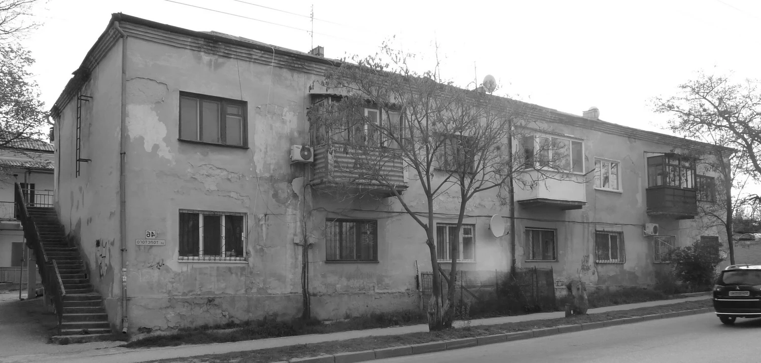 Фасад двухэтажного каменного жилого дома в исторической части Севастополя.