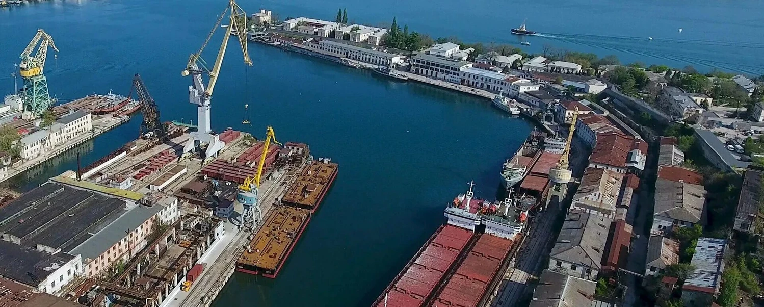 Вид сверху на акваторию и судоремонтные мощности Севастопольского морского завода (Севморзавод) — пример промышленной недвижимости города.
